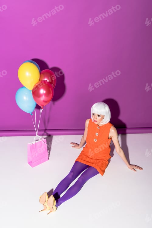 Preview: Gorgeous girl in white wig with air balloons sitting on purple background