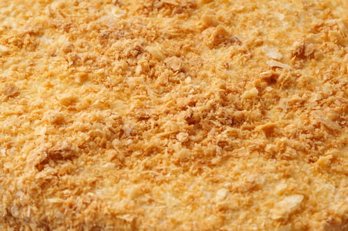 Preview: Crunchy texture of golden baked bread crumbs ready for use in cooking or as a topping for various