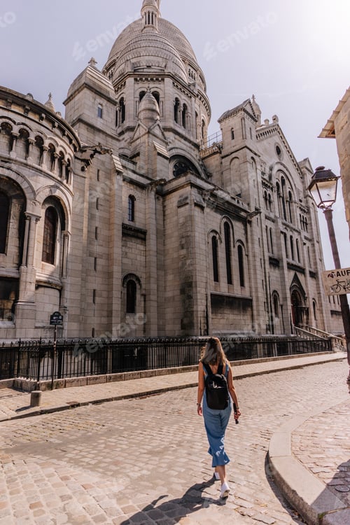 Preview: Woman walking in front of Sacre Coeur basilica