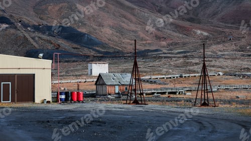 Preview: Industrial remnants and mountainous terrain in Pyramiden Svalbard during daylight