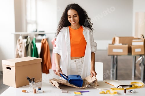 Preview: Designer Wraps Handbag in Boutique, Preparing Parcel In Clothing Store
