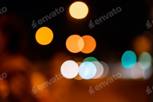 Preview: Bokeh traffic light at night in the street of a big city for background