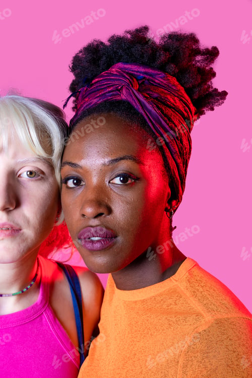 Preview: Portrait of two diverse women friends posing isolated background standing for equality