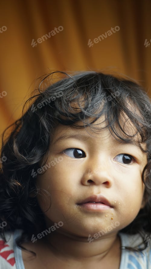 Young Child Portrait with Curly Hair Indoors