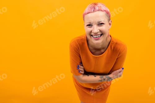 Preview: Extraordinary beautiful woman with short pink hair and big tattoo on her hand smiles isolated on