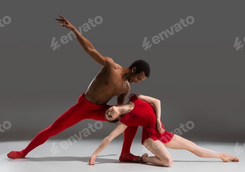 Preview: Couple of ballet dancers posing over gray background