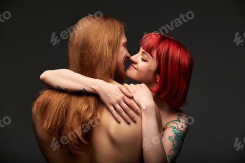 Preview: Sexy passionate couple in love in the studio. The woman's arms embrace a handsome half-naked man