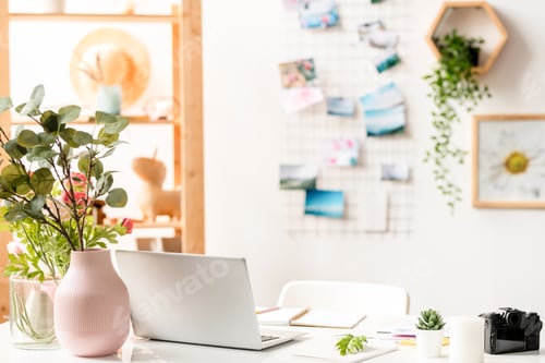 Preview: Workplace of designer with laptop, office supplies and floral compositions