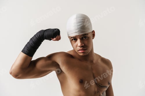 Preview: Young shirtless sportsman showing his bicep at camera