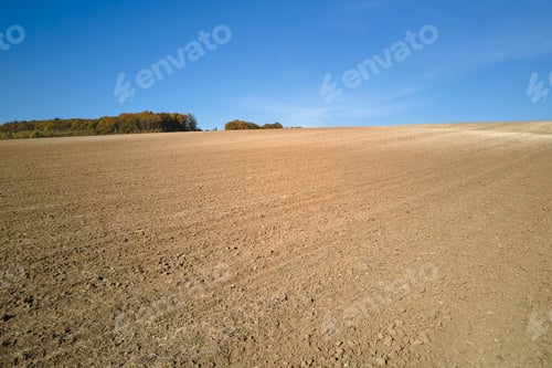 Preview: Plowed agricultural field with cultivated fertile soil prepared for planting crops in spring