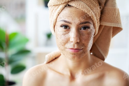 Preview: Beautiful young woman with scrub mask in spa salon