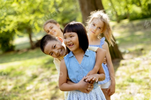 Preview: Group of asian and caucasian kids having fun in the park