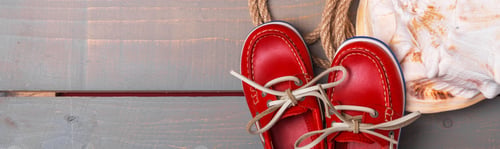 Preview: Banner of Red boat shoes near big shell and rope on wooden background.