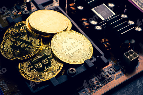 Preview: Golden coins with bitcoin symbol on a mainboard.