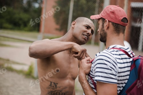 Preview: Side view portrait of two young men having conflict