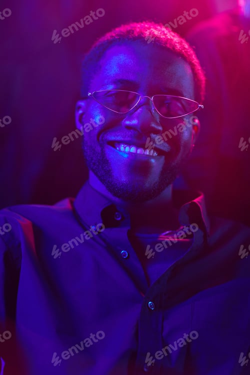 Preview: Portrait of Smiling African American Man in Neon Light