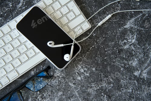 Preview: Office desk with keyboard and headphones.