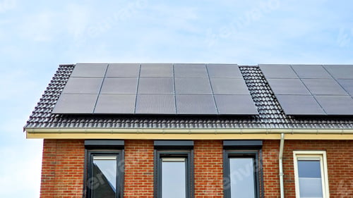 Preview: Newly build houses with solar panels attached on the roof against a sunny sky