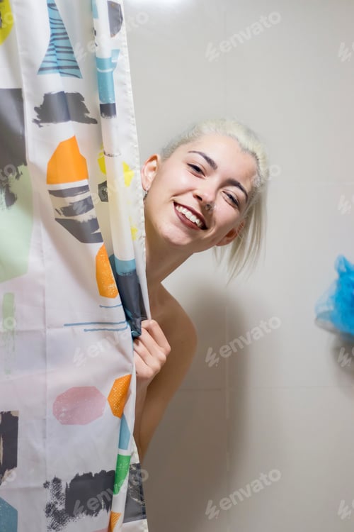 Preview: Beautiful smiling woman covering her body with shower curtain