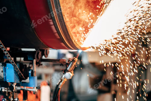 Preview: Closeup of the welding process of steel pipes in a factory with a blurry background