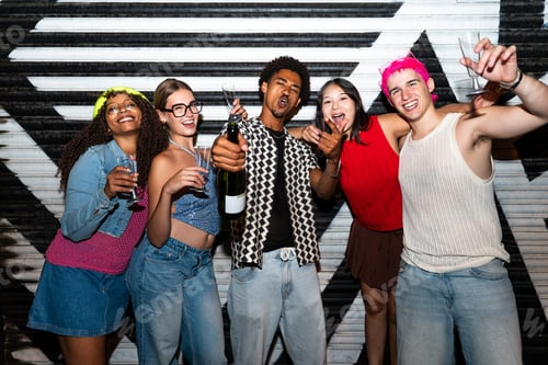 Preview: Multiethnic group of young friends having fun on the stretts in the night
