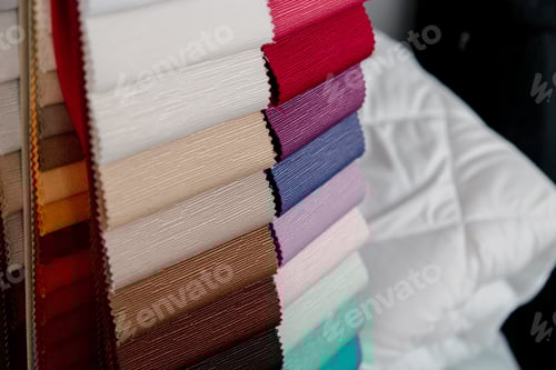 Preview: Lot of colorful folded textiles in a studio