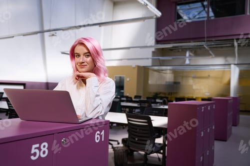 Preview: Woman sitting in coworking space and working online