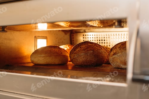 Preview: Bread is baked in the oven. Bakery concept.
