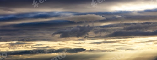 Preview: Storm clouds, colorful, heavy, fluffy on the sky background, at sunset, sunbeams through them.