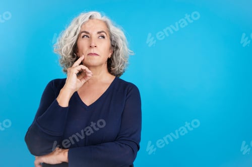 Preview: Mature woman gesturing and looking up with thoughtful expression