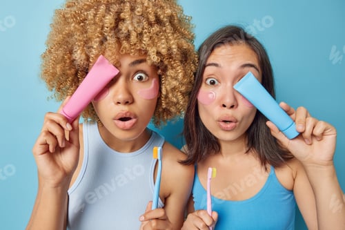 Preview: Teeth whitening and dental care concept. Shocked surprised women hold toothpaste and toothbrush