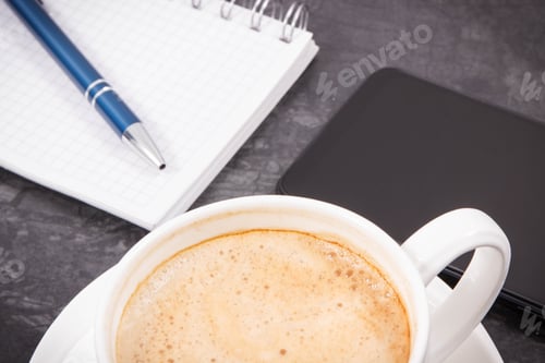 Preview: Mobile phone, coffee with milk and notepad for writing notes. Work or relaxation