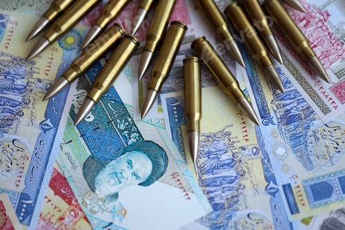 Preview: Many bullets and iranian rials money bills close up. Concept of terrorism funding