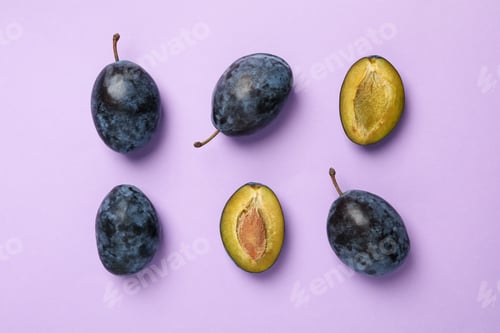 Preview: Flat lay with plums on violet background, top view