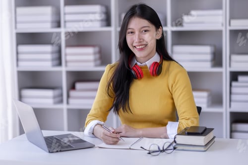 Preview: Young adult happy smiling Hispanic Asian student wearing headphones talking on online chat meeting u