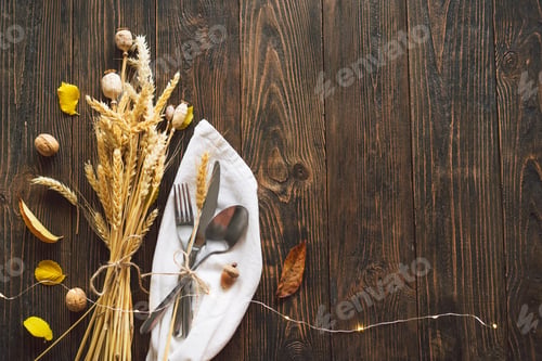 Preview: Autumn composition with leaves, ripe pumpkin and Thanksgiving turkey on a dark wooden table.