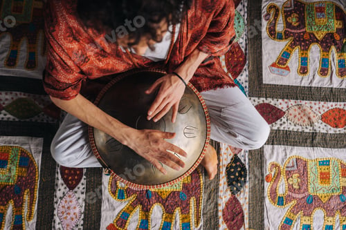 Preview: Close-up of a man's hand playing a modern musical instrument, the orion reed drum