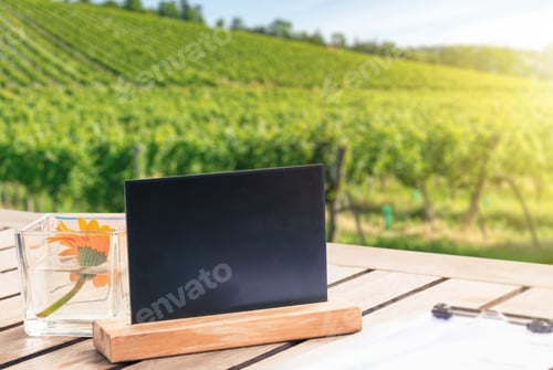 Preview: Table topbl ackboard template against vineyard