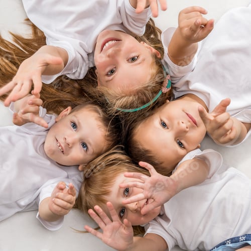 Preview: smiling children lying with their heads together