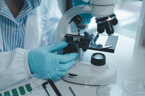 Preview: chemist is doing an experiment in the laboratory, A scientist is using a microscope to analyze the c