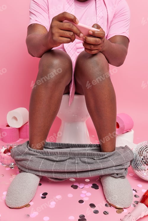 Preview: Cropped shot of dark skinned man addicted to video games plays on modern smartphone while sitting n