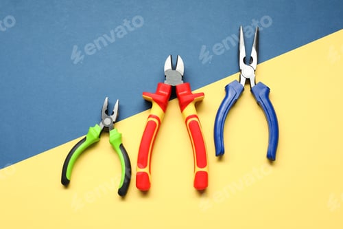 Preview: Different pliers on color background, flat lay
