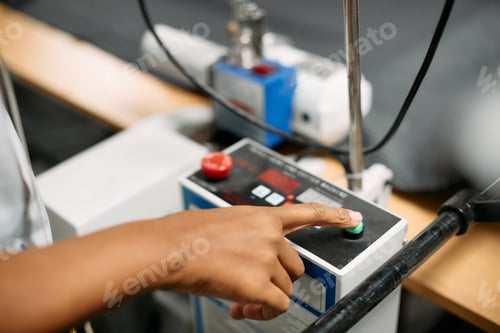 Preview: Close up of textile worker staring a machine while working in a factory.