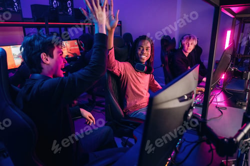 Preview: Celebrating victory. Gamers are playing video game by computers
