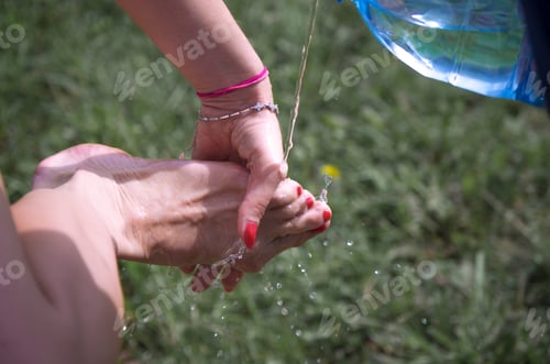 Preview: girl washes her feet outside,