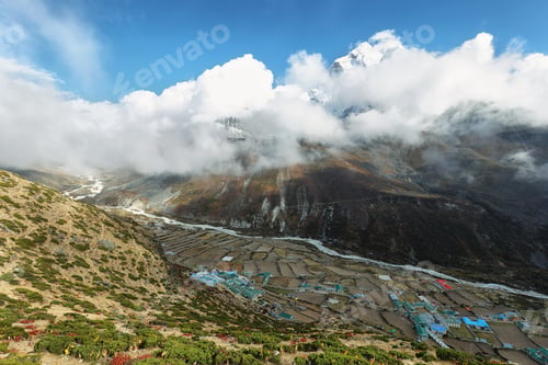 Preview: Dingboche village with Ama Dablan peak behind between clouds
