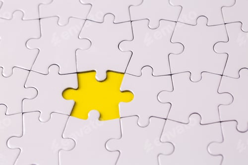 Preview: Fragment of a folded white jigsaw puzzle and a pile of uncombed puzzle elements against