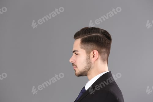 Preview: Portrait of young man with beautiful hair on grey background