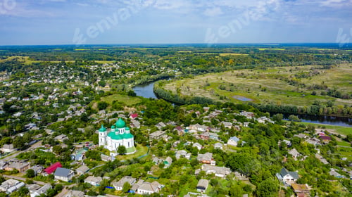 Preview: Bird's eye view of an old church in a village on a beautiful summer day.