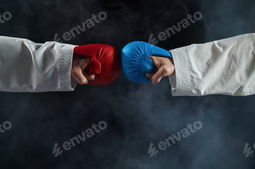 Preview: Two male karatekas hands in gloves, combat concept